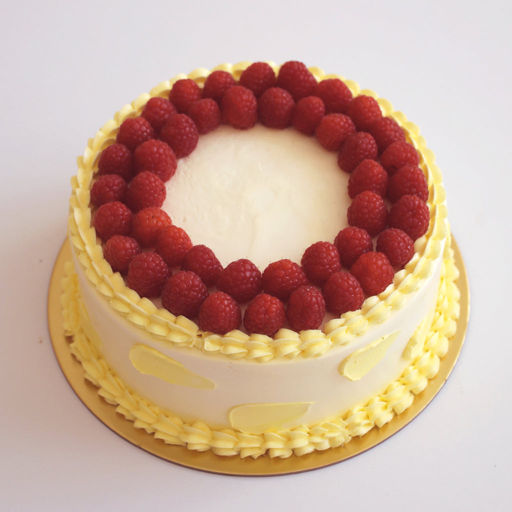 Cake with red berries on a white background